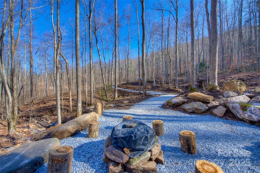 CLEAN | PURE | MOUNTAIN LIVING

Prime 4.2-Acre Mountain Retreat – Shadowood, Spruce Pine, NC

Discover your dream mountain home site on this stunning 4.204-acre parcel in the desirable Shadowood Community, just off US Hwy 19-E near Spruce Pine, NC. Priced at $189,180, this private lot offers mature hardwood forest, rolling terrain, & breathtaking long-range mountain views—perfect for raising a family or enjoying retirement in a park-like setting.

Enter via a newly installed bluestone driveway flanked by two boulders—ideal spot for your family gate, creating your own secluded mountain enclave. Crystal-clear headwaters of Brushy Creek originate on the property, winding through with soothing sounds & natural beauty at your doorstep.

Key Features – Exceptional Value

*Brand-new 3-bedroom septic system installed & ready
*Electric available at neighboring property (low hookup cost)
*Pure mountain spring water piped & ready to tap—some of the cleanest in North America
*Thoughtfully designed fire pit area w/ stone seating & accents for stargazing evenings
*Professional site prep: multiple level building sites cleared, graveled drives & pathways in place, minimal grading needed
*Scenic gravel paths & stone steps blend into the landscape, leading to peaceful creek views

Shadowood is a mature ~130-acre community with diverse homes—from modest to high-end—set in an almost National Park-like atmosphere. Well-maintained, easy-grade roads (built & cared for by a top Western NC road builder) connect the neighborhood. Enjoy Appalachia's rich ecosystem, abundant wildlife, & protected mountain views.

This turn-key ready lot has the hard work done: choose your home placement among gentle slopes & wooded vistas. Build a cozy cabin, modern escape, or full-time residence amid serenity & natural splendor.

Low-restriction community with easy access to amenities: minutes to Spruce Pine (downtown, Penland School of Crafts, Grassy Creek Golf & Country Club, hospital, new  state-of-the-art fitness facility w/ indoor pool). 10 min to Blue Ridge Parkway adventures; 15 min to Burnsville; 30 min to Grandfather Mountain, Linville Falls, Lake James, Marion & I-40; 50 min to Asheville; 60 min to Johnson City, TN & Tri-Cities Airport; 2 hrs to Charlotte.

Every drive to the post office or grocery becomes a scenic journey most people only dream of. Leave the "downcountry" stress behind—let the altitude improve your attitude.

This isn't just land—it's your private slice of Blue Ridge paradise. Mountain living starts here.

Contact today for a private tour & claim this mountain gem!