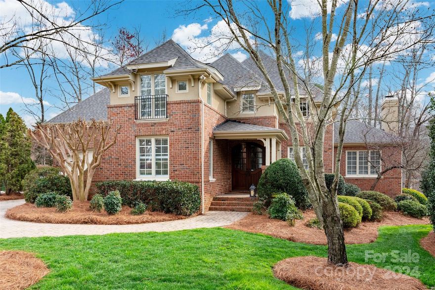 Double mahogany doors greet you as you step into this custom home in desirable Ballantyne Country Club.  Built by Chris Kearns, it boasts stately features like heavy moldings, uniquely carved archways, a dome ceiling, tongue and groove ceiling and stone fireplace.  The kitchen has warm wood cabinets with quartz counters, new stainless appliances and a brick accent wall surrounding the cooktop.  Cozy up to the fireplace in the keeping room. There is a guest BR on the main and three others up with a bonus room.  In the basement, relax or entertain in the family room, enjoy the bar area with a microwave, a beverage refrigerator, wine cooler, dishwasher and sink.  You'll find another BR and full BA as well as a gaming/movie room. Neutral paint with refinished hdwds and new carpet.  Enjoy the outdoors with a paver patio and sport court in the backyard that could easily host a pool.  Sip tea on the covered veranda!  This home has a paver driveway, brand new roof and situated in a cul de sac.