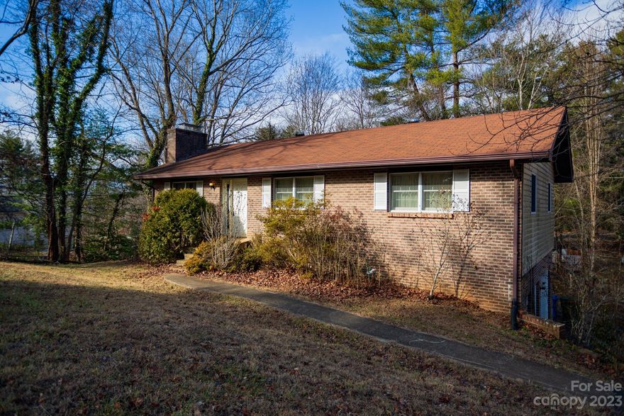 Come take a look at this great home with a lot of potential in desirable Haw Creek. Three bedrooms and one and a half bathrooms on the main level with dining area, kitchen and a well-lit doorway that can let in nice cool breeze come in across the back deck. The living room has a sweet wood-burning fireplace and nice wide windows. Need extra storage? A workshop? No problem! Check downstairs. A wood stove is down there too and it keeps the place nice and toasty. This house is located on a cul-de-sac road so traffic is pretty minimal. You can hear the trickle of a nearby creek and chirping birds in the peaceful neighborhood. 
With a few improvements and a vision you’ll be able to make this well build house your own!
