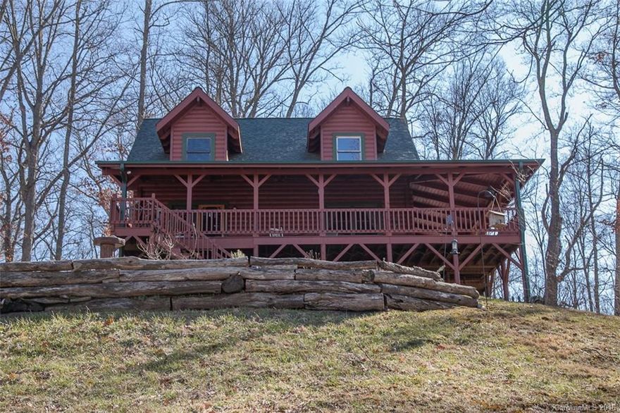 FIREFLY CABIN @ 3000’  Custom log home. 6.12 very private, quiet acres. Views! 10’ wide decks, wrap ½ the house. Hot-tub. Inside, the aroma of pinewood everywhere. Open concept design; sunny rooms; tree-beamed greatroom open to roomy kit w/reclaimed barn-wood cabinets, rhododendron railings, main-level MBR w/ensuite bath, large loft w/adjoining 2nd MBR, full lower level 2-BDR suite w/separate entrance. 5 mins-Mars Hill, 26 mins-Asheville.