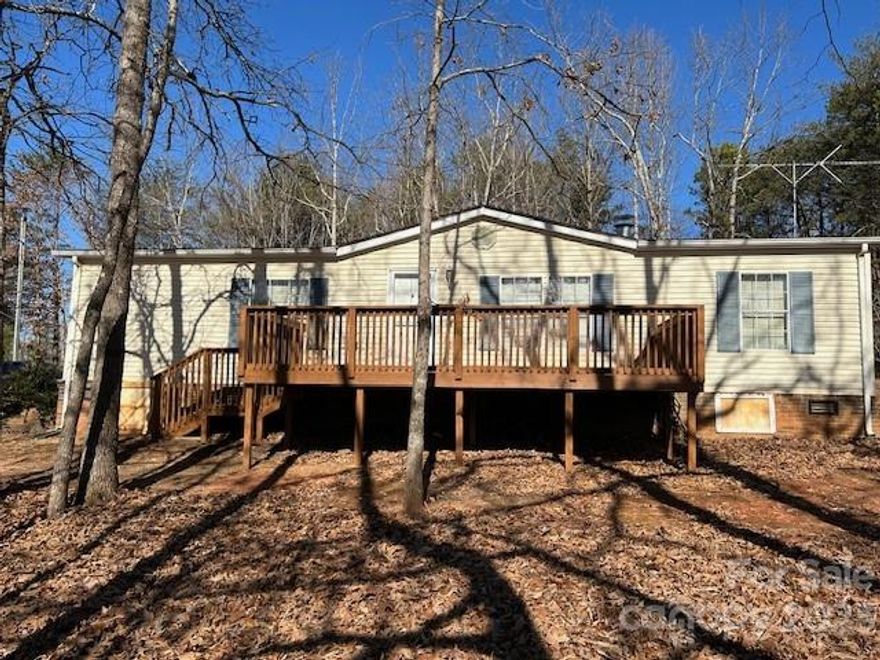 This home is Move-In Ready!  You'll love the private setting, the distant mountain view & beautiful sunsets you'll enjoy from your deck!  This 3 BR,2 BA  home is on 1.83 acres & has a nice storage bldg with electricity that would make a great workshop.  Large kitchen comes with all appliances including very nice washer & dryer located in the laundry closet. Pantry cabinet also stays.  This home has an open floorplan with split bedrooms.  The primary bedroom has two closets and the primary bath has double vanities, garden tub and walk-in shower.  The large family room has a beautiful gas log fireplace w/fan and there's a nice large deck on the front of the home. New heat pump installed in Sept. 2020 and new roof March of 2021.  Side deck has a Sunsetter awning to use while you enjoy this country setting!  This DWMH has been "detitled" and is now considered real property. Seller knows of no problems but home sold AS IS.  Located approx. 1 hr. from Charlotte, Asheville, or Greenville,SC.