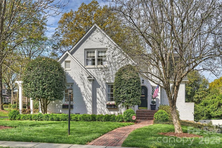 Beautiful white painted brick home in a fantastic Myers Park location, just steps from the Greenway, shops, and restaurants. Charming and inviting, this home offers a wonderful floor plan ideal for both everyday living and entertaining. The updated kitchen features quartz countertops, abundant storage, high-end appliances, a bar with  a beverage fridge, and a breakfast nook. A spacious great room addition opens to a porch overlooking the manicured backyard. The main-level primary suite includes a stunning ensuite bathroom with dual vanities, a soaking tub, frameless glass shower, and two walk-in closets. Upstairs offers two secondary bedrooms, a full bathroom, and walk-in attic storage. The finished walkout basement provides valuable flexibility with a bonus room, renovated full bath, and direct access to a large covered terrace designed for dining and lounging, anchored by a built-in fireplace. A lovingly landscaped, fenced rear yard completes this special property. Welcome home!