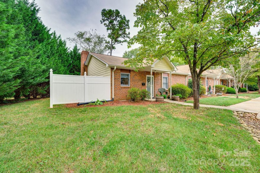 Charming one-level townhouse in a small, cozy community. This home is perfectly situated near major highways like I-40, 321, and Hwy 16. The inviting foyer leads to the kitchen, which features a pass-through to the dining area and den. The spacious den boasts a fireplace and a private door to the generous side patio. The primary bedroom is oversized, complete with a ceiling fan and walk-in closet. The guest bedroom is roomy and includes pull-down attic access. Relax and unwind on the private patio, or start your day by the warmth of the gas log fireplace. The kitchen comes equipped with stainless steel appliances, and the washer and dryer are included! This end unit is move-in ready!