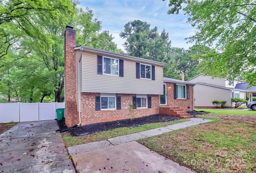 Excellent location just 10 miles from Center City and a short drive to all that Uptown and Charlotte has to offer.
Charming curb appeal beneath the shade of mature trees. The main level features a bright living room that flows into the kitchen with matching stainless steel appliances, ample storage, and an attached dining area. A sliding glass door fills the space with natural light and opens to an expansive deck overlooking the flat, fenced backyard.

The lower level provides additional living space with a cozy den and a full masonry fireplace with raised hearth. Upstairs, the primary bedroom offers an en-suite bath, accompanied by two secondary bedrooms and a full hall bath.

Move-in ready and full of character and ready to welcome its next owner.