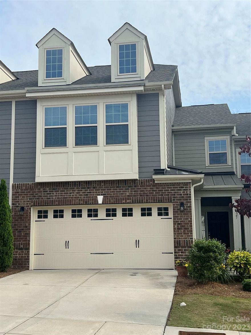 Move Right In!Absolutely adorable unit in desirable Tega Cay! Beautiful HW Floors thru-out first level. Crown molding/chair railing in Entry Foyer. Open plan w/huge kitchen island, designer pendant lighting, subway backsplash, granite, SS appliances. Raised Desk/Work Station w/Overhead Cabinets PLUS Large walk in Closet under stairs (currently being used as home office.) Great sized walk-in pantry. Enormous Great room(pre-wired for ceiling fan). Lovely Dining Area w/Sliding Glass Doors to Expanded Rear Patio, steps down to Grassy area overlooking Heavily Treed View. Over-sized Primary Bedroom w/Trey Ceiling, Primary Bath w/Tiled Floor, Tiled Shower Surround plus huge Garden Tub. Two good-sized Secondary BRs, One w/Built-In Desks (to Remain), Dual Sink Vanity in Both Baths.  All BRs are pre-wired for Ceiling Fans. 2" Blinds throughout for great privacy. Over-sized Garage w/Room for add'l storage/shelving. Because of Multiple Offers, seller is asking for highest & best by 5/25 at 5:30pm