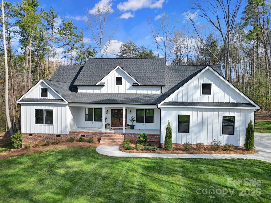 Welcome to picturesque Irongate Farms in Clover, SC! This stunning rustic Craftsman home, built in 2023, features 4 bedrooms and 3.5 bathrooms, nestled on a scenic pond with breathtaking water views in an idyllic country setting. Step inside to an open floor plan that blends the spacious gourmet kitchen, great room and dining area. Soaring vaulted ceilings with beautiful, custom wooden beams adorn both the kitchen and great room. The kitchen boasts a spacious island, sleek stainless steel appliances and smooth countertops. The luxurious primary suite on the main floor features a spa-like bathroom with opulent finishes for the ultimate retreat. Outdoors, relax or entertain on the expansive terrace or covered porch.  Enjoy fishing on the fully stocked pond.   Set on over an acre of private land, this estate offers elegance, seclusion and sophistication in one of Clover’s most coveted communities.