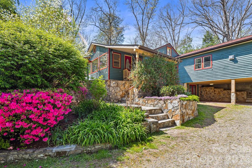 Only 1.3 miles from downtown Black Mountain, this 1930-built home combines its original vintage charm with modern updates on a large, fully-fenced lot with stone terraces, mature landscaping, pollinator garden and mountain view. The home features a spacious split-bedroom floorplan with sunroom, dining room with stone wood-burning fireplace, and large living room with natural gas woodstove. Non-heated living area includes 393 sqft flex space/storage in the attic walk-in above dining room, 315 sqft partially finished/heated walk-out basement with wet bar, and 237 sqft basement half bath with macerating toilet and laundry/storage room - for a combined total of 3,265 sqft interior living area. Full kitchen remodel completed in August 2023 showcases a 700-year old Cypress live-edge countertop with blue resin accents, Thor professional 6-burner gas range and hood, new cabinetry, and new stainless steel appliances except for Samsung EnergyStar refrigerator with sparkling water dispenser and trash compactor. The primary suite includes its own gas woodstove, built-in window seat, dual walk-in closets, changing area, and ensuite bath featuring tiled shower with double showerheads, claw-foot tub, and radiant floor heat. Additional highlights include walk-in pantry, radiant floor heat in remodeled hall bath, additional attic storage above primary suite with pulldown stairs, EV charging station, 30-amp RV service with sewer hookup, 417 sqft workshop, rear screened porch, and solar entry gate with keypad. Contact agent for list of unpermitted upgrades. This unique home is perfect for a private mountain retreat with the convenience of being close to town amenities. Also a great short-term or long-term rental investment opportunity! Pre-Listing Home Inspection Report available and repairs made by Seller.