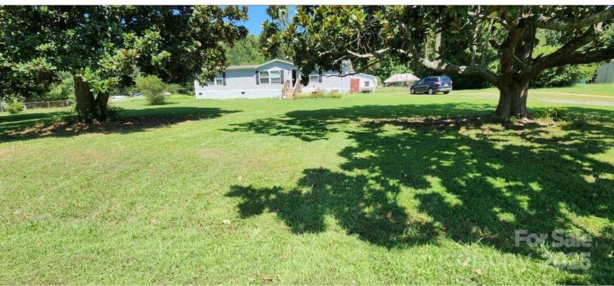 Country setting with outdoor workshop/storage building on an acre lot make a great setting for this nice 3BR/2BA home with open-floor plan in the Clover School District, near downtown and just minutes to York & Lake Wylie.  Home offers all appliances, newer 8x16 back deck and newer partial backyard fencing for privacy and pets. Building out back would lend itself to a great workshop, hobby room, get-away or party place.  Other fencing & additional detached covered shed for animals beside the workshop. No city taxes and no HOA.