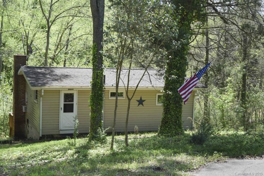 Lakefront get-away in the heart of Lake Wylie!  This cabin is a nostalgic delight, perfect for a weekend retreat or cozy full-time living. You will love the pine paneling, wooded 1 acre lot, and natural setting. Launch your canoe or john-boat right from the shoreline, and paddle or fish to your heart's content. Kitchen open to living area, and big screened porch overlooking the water. Tucked in a quiet cove, but oh-so-convenient to restaurants, shopping, and conveniences of town. Terrific value!