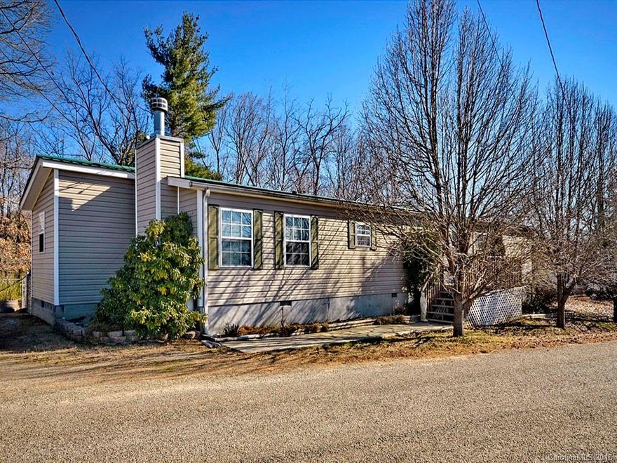 Large and open 4 bedroom, 2 bath home on 1 acre! Den with gas logs open to updated kitchen. Separate living room, dining area, split bedroom plan with extra storage. Metal roof, covered back deck, partial fenced yard, and utility shed for storage. $ 2000 carpet allowance. Conveniently located 5 minutes to town & shopping.