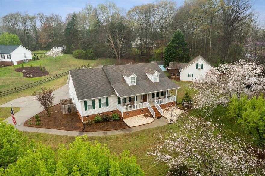 Rare Find in Rock Hill,Updated 3 bed and 2 full bath Ranch Home on a corner lot with over an acre fully fenced,Updates-Hardwood floors, granite in kitchen and baths,Plantation Blinds throughout, Huge dining area open to the great room .Travertine floors and shower in primary bath.Big great room with fireplace,View the pond from the rocking chair front porch .Pull in through electronic gates right into your two car carport.Vacation at home with 18x36 Salt Water Pool and big deck area . RV parking and power hookup . Detached garage w 2nd living quarters included 1 bed and 1 bath or office with big bonus room above , the garage has a workshop as well .Space for your home business with separate gated entrance , home has two driveways .Save on electricity with Solar Panels just 2years old .New HVAC in 2022.Heat on demand system 1 year old. Second carport for boat storage . Garage built in 2002 , shed for more storage .2nd living Q/Office,Bonus in garage, private entrance and gate .