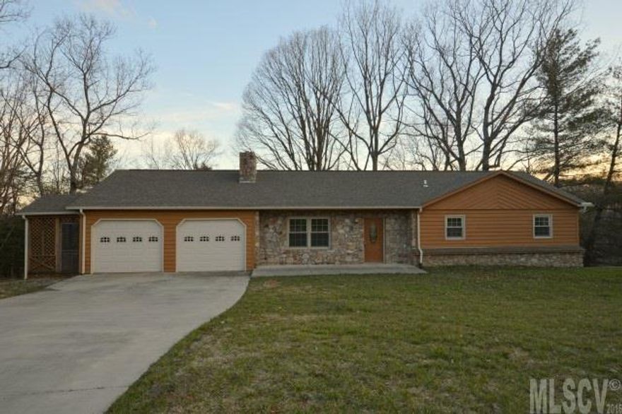 Beautiful 3 bedroom, 3 bath home has had numerous updates. New in mid 2014 are the roof, heat pump, windows, custom built oak cabinetry, granite countertops, hardwood flooring in the living room and hall, porcelain tile flooring in kitchen and baths, carpeting in the bedrooms, 4 insulated garage doors, and two garage door openers! The living room has a beautiful stone fireplace and two lots come with this home. The third bathroom is in the basement and there's plenty of room to add a den if desired. The laundry room is just off the kitchen but doesn't have a vent, so it's not counted in the heated square footage. There is an unheated room just off the garage that would make a great office if heating and cooling were added. Great for storage as is.