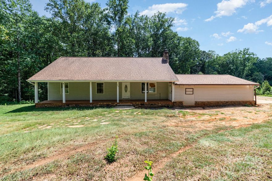 Enjoy total privacy on this secluded 1-acre lot with a peaceful stream running through the back of the property. Relax on the full-length front porch or take in wooded views from the new large kitchen window and sliding door that bring nature indoors. This home features an open floorplan with numerous updates throughout, including recessed lighting and a bright, airy layout. The closed-in double garage is currently used as a workshop. A tall crawlspace offers ample storage. The septic permit is for 3 bedrooms, but the home includes 4 with no known issues. A rare opportunity to live in harmony with nature while enjoying modern comforts!