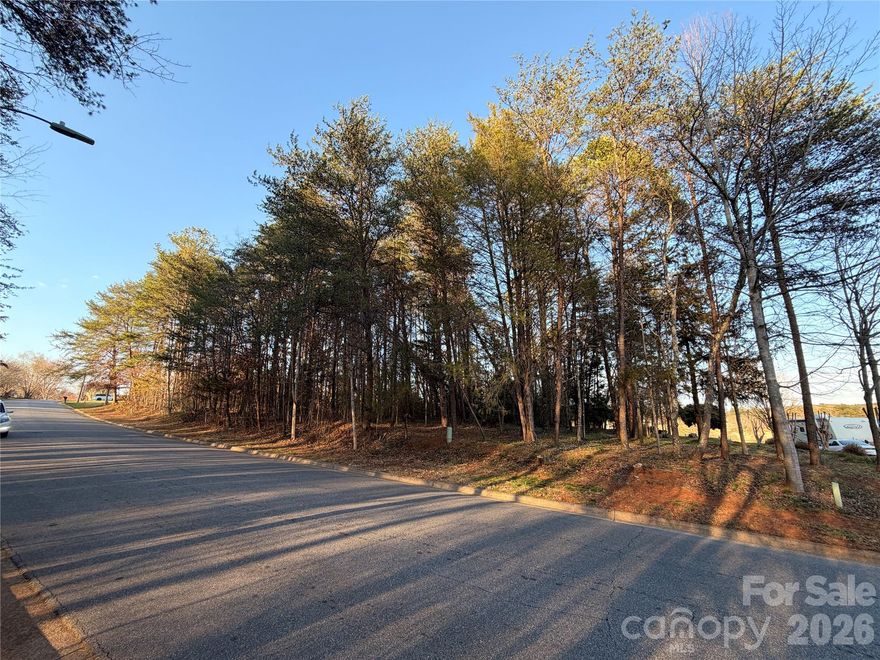 Back on the market at no fault of the seller, this .58 golf course facing lot sits directly along the fairway at Lake Hickory Country Club’s Catawba Springs course, offering daily front-row views of one of Hickory’s premier private golf facilities. It's next door lot (3779) can be combined for a larger 1.2 acre estate lot if desired.  Tucked into the established Catawba Springs Golf Community in northeast Hickory, the lot combines a peaceful residential feel with the convenience of being inside the city limits and just minutes from shopping, dining, and major roads.

Wake up to manicured fairways, mature trees, and the quiet rhythm of play unfolding just beyond your backyard as golfers finish out the hole in full view. Instead of driving to find green space, you can enjoy your morning coffee on a future patio or screened porch while watching approach shots, putts, and sunsets over the course. Evening walks follow tree-lined streets where many homes are positioned to take advantage of golf views, creating a neighborhood atmosphere that feels relaxed, social, and connected to the outdoors.

Life here is centered around Lake Hickory Country Club, which operates two facilities and describes itself as the premier private country club in Hickory with a “best in class” experience across golf, tennis, fitness, dining, and social amenities. At the Catawba Springs campus, members enjoy 27 holes of private golf, a full practice facility, and a clubhouse that serves as a social hub for dining, drinks, and events. Food and beverage service includes bar, grill, and restaurant offerings, and the club also provides meeting and banquet facilities for gatherings, celebrations, and special occasions.

Beyond the course, active living is supported by additional club amenities such as tennis, fitness, and organized programs for members. The club’s fitness center features aerobic machines, free weights, an indoor racquetball court with viewing area, men’s and ladies’ locker rooms, and steam or sauna facilities, along with classes like spin, yoga, and conditioning to make wellness a natural part of your weekly routine. Tennis and pickleball options, along with social events and junior activities, round out a lifestyle where it is easy to stay engaged without leaving the community.

Catawba Springs is governed by recorded bylaws and covenants administered by the property owners association, which are designed to preserve the neighborhood’s appearance and protect long-term property values. Owners planning to build or add improvements must also follow the City of Hickory’s land development and building regulations, with the more restrictive of the city or community rules applying, helping to maintain a cohesive streetscape and a well-kept environment around the golf course. Nearby golf community listings highlight city water, sewer, trash, and street lights, along with wired connectivity options, underscoring the blend of resort-style setting and practical everyday infrastructure in this part of Catawba Springs.

With its direct fairway frontage, private-club setting, and access to a full slate of country club amenities, this lot offers an ideal opportunity to design a custom home that feels like a year-round getaway—whether you are hosting friends after a casual round, watching the last group finish as the sun goes down, or simply enjoying the quiet beauty of living right on the golf course.