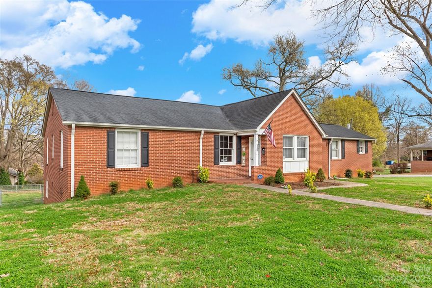 Updated 6 bed/3.5 bath brick ranch home with full basement! Located on a corner lot and walking distance to downtown Morganton, mins from interstate. The home has updated paint, roof in 2015, fixtures and flooring. The main level of home offers real hardwoods, 3 bedrooms, 1.5 baths, and a sunroom. Every room is spacious with ample closet space. The kitchen has SS appliances, updated counters and a pantry. A second entrance holds a 1 bed/1 bath apartment with kitchenette. The basement is mostly finished with a large unfinished storage/utility room. 2 bedrooms, den, office, large full bath and laundry room making this basement a great 2nd living area or could easily be another apartment. There could be 3 separate rental spaces in this property. The attic space has been finished and could be a great kids space or extra entertaining area.