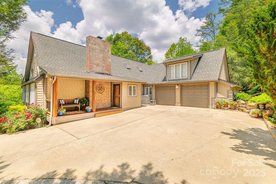 This Reems Creek Golf Community beauty has fabulous curb appeal and sits up a gentle meandering driveway that wraps around to courtyard parking and a spacious 2-car garage & no steps from your car - you enter through the laundry room to the kitchen! 4167 finished sqft on 2 levels with a loft plus decks/patios off each side/level. Vaulted pickled pine ceilings on the main, gorgeous hardwood floors, lots of windows and natural light, gas fireplace with a floor-to-ceiling brick hearth, huge open kitchen to dining & living rooms. Lots of areas for privacy including a primary suite addition with access to private back patio (wired for hottub). Upstairs is great for work-from-home office, Expansive lower level has 3 more bedrooms, porch/patios & a family room! Sellers recently refinished the kitchen cabinetry with solid maple doors along with lots of other updates over the years including new driveway, massive landscaping stones and landscaping stairs, shrubs, retaining walls, the primary suite addition, new interior staircase, bathrooms, windows, ipe decking, porches, patios (ask re the full list). The golf community membership is optional and reasonable with a welcoming social community for spectacular golf, pool, clubhouse with a restaurant, pickleball & more. Furnishings may convey!