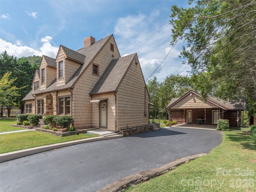 Perched above Hot Springs with commanding long-range mountain views, this one-of-a-kind property blends character, flexibility, and income potential. The 4BR/3BA main home showcases timeless wormy chestnut woodwork, two fireplaces, and a spacious main-level primary suite opening to a covered porch—perfect for soaking in the scenery.

A historic log cabin guest house with separate utilities creates an ideal setup for short-term rental or private retreat, while the large shop/RV garage offers exceptional space for storage, hobbies, or adventure gear. Situated on a double lot with additional parcels, the property provides room to expand or further maximize its income-producing potential.

Located in downtown Hot Springs—a resilient and revitalizing mountain town—enjoy close proximity to the Appalachian Trail, natural hot mineral springs, and endless outdoor recreation including rafting, hiking, and biking. All within an easy drive of Asheville.

Whether you’re seeking a full-time residence, mountain getaway, or investment property, this offering delivers a rare combination of lifestyle and opportunity.