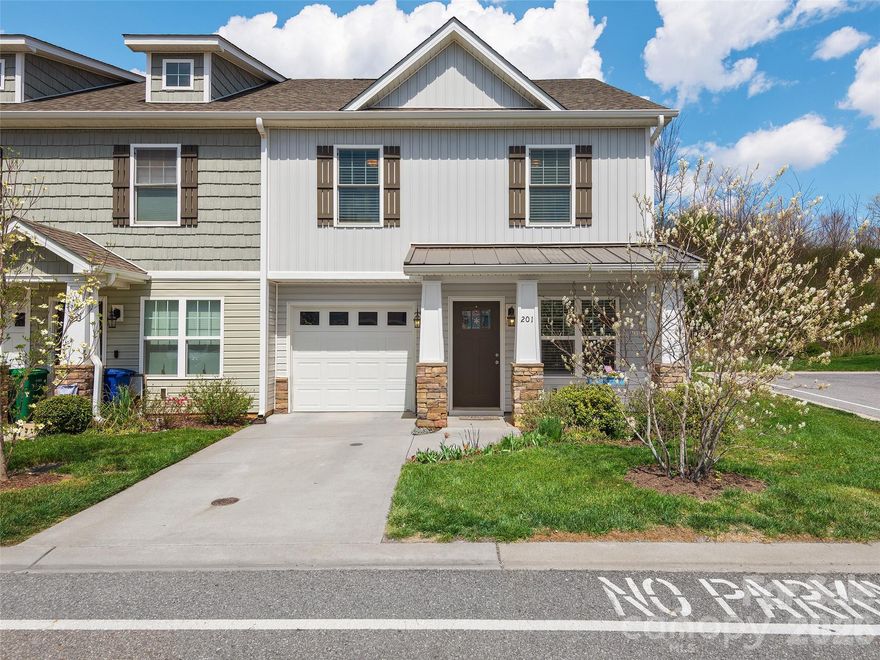 Welcome home to this beautifully maintained end-unit 3-bedroom, 2.5-bath townhome where comfort, convenience, and charm meet seamlessly. Built in 2019 and perfectly positioned on a desirable corner lot, this inviting home offers an open layout filled with natural light from abundant windows. The cozy living room features a natural gas fireplace, perfect for relaxing evenings, while the dining area connects by a sliding glass door to your private patio—ideal for morning coffee or outdoor entertaining. Modern finishes and thoughtful details enhance every space, complemented by access to high-speed internet for work or streaming. Enjoy a prime location just minutes from shopping, restaurants, and grocery stores, with downtown Asheville only 15 minutes away and Waynesville just 30. Whether you’re commuting, exploring nearby attractions, or savoring quiet time at home, this move-in-ready townhome offers the best of both comfort and convenience.