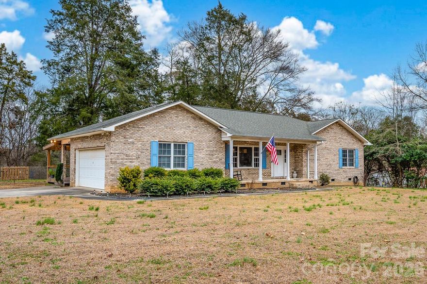Enjoy the perfect blend of country living and everyday convenience with easy access to major roadways, shopping, and downtown Salisbury, Mooresville, and Statesville. Situated on 2.64 private acres, this beautifully updated all-brick 3-bedroom, 2-bath home offers comfort, functionality, and modern finishes throughout.

Step inside to find brand-new bathrooms, updated flooring, luxury vinyl plank throughout the main living areas, tiled baths, and stunning light fixtures that elevate the space. Relax and unwind on the covered front porch or rear covered porch while taking in peaceful views of nature. Outdoors, enjoy the inviting fire pit area and a small creek running through the center of the property, located outside of the floodplain.

Additional features include a shared driveway and GasPak heating system. Backyard shed does not convey. Rarely does a property offer this much privacy, charm, and accessibility all in one setting.