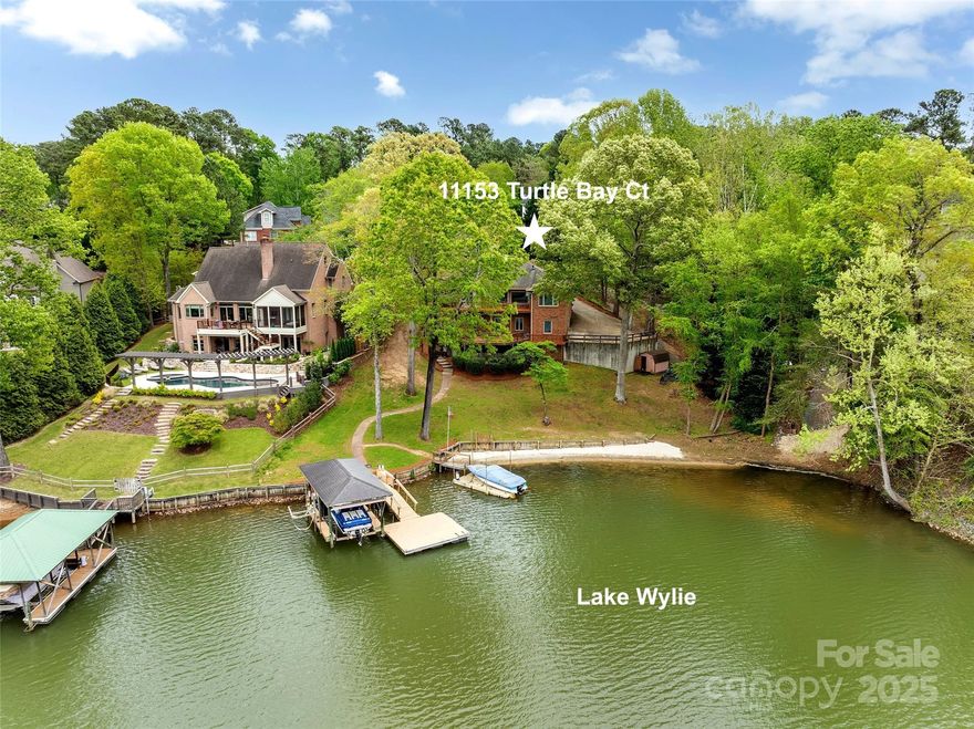 WATERFRONT RANCH with basement in TEGA CAY on LAKE WYLIE in WINDJAMMER COVE!  Beach, Covered boat slip with lift, floating pier, on a .49 acre Cul de Sac lot, Gorgeous backyard!  In the Watertrace neighborhood on the peninsula. Custom Built Brick 3 Bedroom, Ranch with 3 Garage bays. Walk in the front door to stunning lake views from almost every room in this house! Large Great Room with fireplace, Sunroom, Kitchen with dining area, & Formal Dining room. Primary Bedroom with lake views & deck access, large walk in closet, dual sinks, separate water closet, garden tub & shower. Split floor plan, 2 bedrooms & full bath. Basement: Bonus room with wet bar, Office/Guest room, Full Bath. 2 car Garage on Main, 1 car Garage & Workshop/Gym lower level. NO HOA, Fort Mill Schools.  Tega Cay,SC is a recreational city on the shores of Lake Wylie. Beaches, boat ramps, parks, trails, tennis, pickleball, Tega Cay Golf Course, Tega Cay Beach & Swim Club & more.