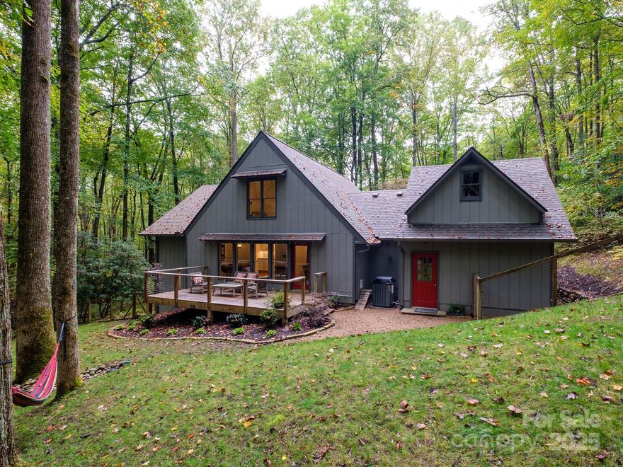 Discover the charm of mountain living in this beautifully updated cottage tucked away at the end of a quiet cul-de-sac in Connestee Falls. Set on 1.9 acres of rolling, storybook landscape, this home feels worlds away, yet is close to all of the community’s premier amenities.

Step inside to find hardwood oak floors and a brand-new kitchen with modern finishes throughout. The inviting living room features a 2 story great room with vaulted ceilings and a gas fireplace. The living room also opens to a spacious back deck overlooking the tranquil woods. On the second level you will find a primary suite with a fully renovated primary bathroom, a large walk-in closet or dressing room and a comfy sitting area or office overlooking the living room. 

With three bedrooms and two baths, this home offers flexibility for guests, hobbies, or a home office. The unfinished space above the garage would be perfect for an art studio or exercise room. Outside, enjoy beautiful hardscaping and landscaping, along with a fenced yard ideal for dogs. The setting is exceptionally private, making this property a rare retreat within Connestee Falls’ vibrant, amenity-rich community where lakes, trails, golf, and waterfalls await just beyond your door.