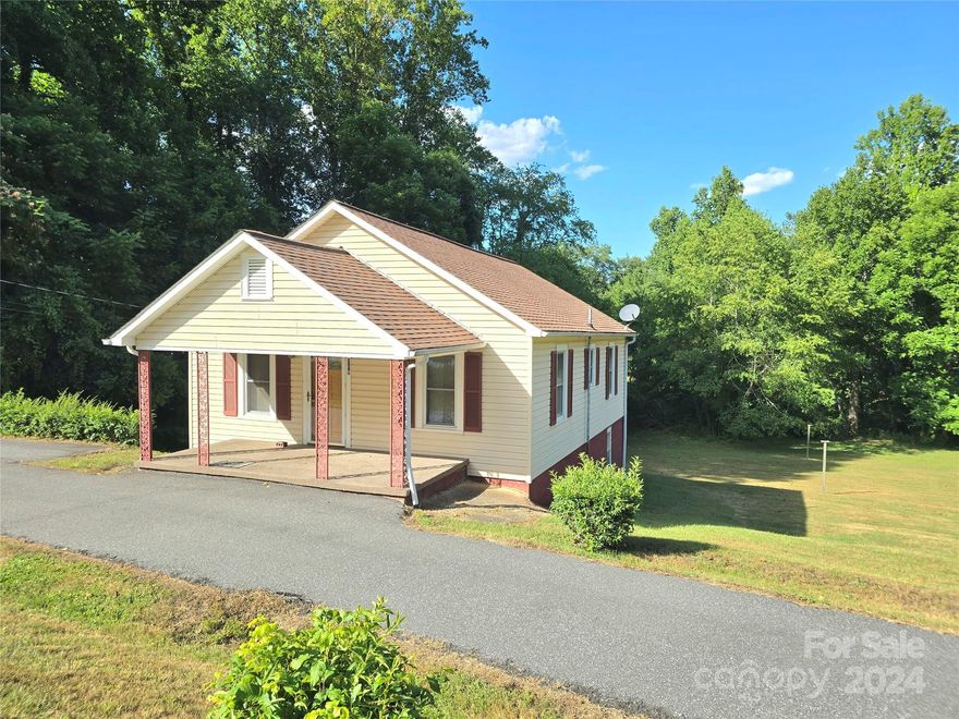 Charming 2BR/1BA cottage on a sprawling 1.16 acre lot in the quaint town of Glen Alpine! Just 15 minutes from Lake James access, state park and Fonta Flora hiking trails.  Located on a quiet street just steps to sidewalk access~many neighbors enjoy exercise throughout the town. Well-loved and owned by one family for many years.  Beautiful hardwood floors throughout the living room and primary bedroom.  Bathroom has been updated with a large, walk-in shower, new flooring, and white pedestal sink.  Large, open kitchen features a cafe-style dining area.  Back porch has a laundry connection for a stackable washer/dryer that remains.  Full, unfinished basement has exterior access and hatch-style interior access from the back porch.  Outbuilding is great for extra storage.  A small creek runs along the large back yard.  There is plenty of room for a garden and recreation area.  Nice covered front porch.  Circular drive.