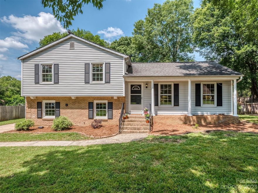 Fantastic South Charlotte location in lovely established neighborhood on a large level lot with privacy fencing around the open back yard. A covered front porch greets visitors into the spacious, bright living room. Inside, this roomy split level has new neutral paint, solid oak wood floors in the living room, dining area, stairs, hall & the upper level bedrooms. A sliding door opens out to the large back deck off the kitchen, great for festivities or just relaxing. The bathrooms & mud/laundry rooms have tile floors. The primary bathroom was nicely renovated at an earlier date. Bedroom 4 is in the lower level along with the den, charming brick wood burning fireplace and a convenient half bath. New HVAC system in 2022, roof replaced in 2008, new kitchen appliances. NO HOA! Terrific access to I-485 & I-77. Lots of shopping within walking distance, and expansive medical facilities just across Pineville Matthews road. Easy access to Uptown Charlotte & the airport. Schedule a showing today!