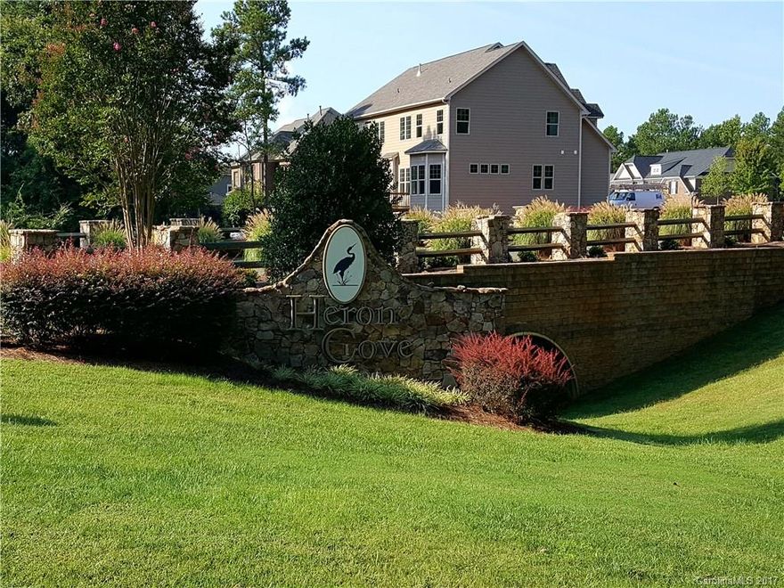 Location, Location, Location!!! Gorgeous wooded corner home site in sought after prestigious Heron Cove, Located in the heart of Lake Wylie.  Build your distinctive custom home from a select list of pre-approved builders, this secluded community is only 20 minutes to uptown Charlotte, convenient to shopping, dining, CLT Douglas airport and is assigned to award-winning Clover Schools! Very few opportunities remain in this stunning community, don't miss out on your dream home!