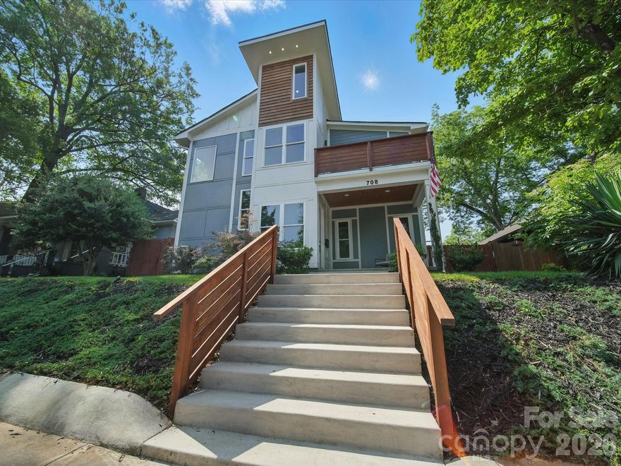 Heated saltwater pool. Walking distance to the restaurants, bars, and coffee shops of Midwood and Elizabeth. That combination rarely comes available — and this modern 2020 build delivers with the scale and design to match: 5BR/4.5BA, 3,800+ sq ft, soaring ceilings, and clean contemporary finishes throughout.

The main level opens into a light-filled, high-ceilinged living and kitchen space that flows directly to a covered patio and travertine pool deck. The kitchen is serious: 48" gas range, column fridge/freezer, waterfall quartz island, and a walk-in pantry. A main-level guest suite handles guests, in-laws, or a dedicated home office with ease. A half bath off the pool and built-in gas grill line round out the outdoor living setup.

Upstairs, the primary suite offers dual closets, soaking tub, seamless glass shower, and a private terrace. A flexible loft and three additional bedrooms give the floorplan room to breathe. Garage washer/dryer hookups and thoughtful storage throughout.

The backyard backs to a quiet neighboring business — no rear neighbors, just privacy and green space around the pool. Little Sugar Creek Greenway (19.5 miles of trails) steps away, Lynx Sunnyside Station within walking distance, and the full breadth of Midwood's dining and shopping at your doorstep — including Sip City, Two Scoops, and Central Coffee just two blocks away. Move-in ready.