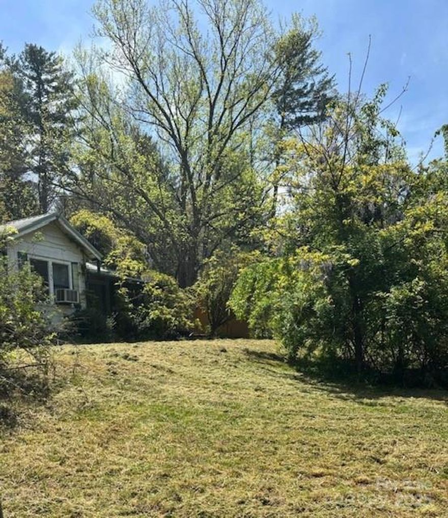 BRING ALL OFFERS !
Investment Property - great opportunity to own a corner lot with house on an acre in a fast growing area of Hendersonville. The property is being sold As Is and includes the main house, large detached garage and two outbuildings. This could be a great single home to live in or use as an income producing rental. Approximately 1/2 mile from I-26 and minutes to grocery, shopping and city.

Buyer to verify zoning options for commercial or multifamily use. The surrounding area has multi zoning types.
City water and sewer is available in the area buyer to verify.