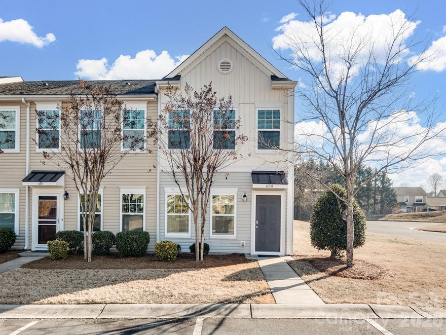 Welcome home to this beautifully maintained 3-bedroom, 2.5-bath end-unit townhome in the Steele Meadows neighborhood of Fort Mill. With extra windows and an abundance of natural light, this home feels open, bright, and welcoming from the moment you step inside. The main level offers a seamless flow between the living room, kitchen, and dining area - ideal for both everyday living and gathering with friends. The kitchen is thoughtfully designed with beautiful cabinetry, granite countertops, and a spacious island with breakfast bar seating.  Upstairs, the primary suite provides a comfortable retreat, complete with an en-suite bath featuring a soaking tub/shower combination. Two additional bedrooms share a full bath, and the upstairs laundry room adds convenience exactly where you need it. Freshly painted walls give the home a clean, move-in-ready feel. Step outside to enjoy the covered side patio with a spacious utility closet - perfect for additional storage. As an end unit backing to a large common area, you’ll appreciate the added privacy and open green space just beyond your door.