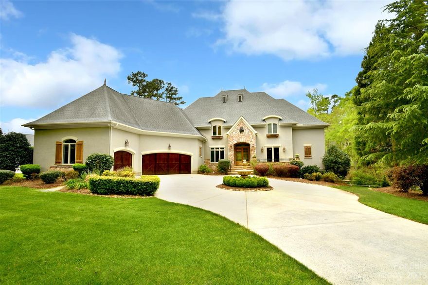 Welcome to this exquisite luxury home located in the highly sought-after neighborhood, The Point, boasting breathtaking waterfront views and a sparkling pool. This stunning property is the epitome of luxury living, offering an unparalleled lifestyle of elegance. This home features a spacious family room and a large eat-in kitchen with an expansive island. The kitchen is a chef's dream with a gas range and dual ovens. The ample space and stunning design make this kitchen the heart of the home. First floor Primary bedroom leads to the luxurious bath with dual sinks, soaking tub, travertine tile and steam shower and has access to the beautiful covered porch. Upstairs you will find spacious secondary rooms with private baths, bonus rm and porch.In addition to the elegant living spaces, this home offers a sports court in the basement and offers endless possibilities for entertainment, fitness, and fun. Basement also has media rm and wet bar. Rare property with deeded dock and boat slip!