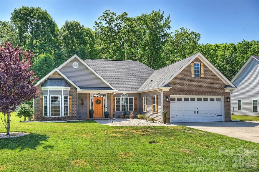 This meticulously maintained ranch home welcomes you with abundant natural light and a bright, open floor plan designed for both everyday living and effortless entertaining. A spacious foyer leads into a versatile gathering area with endless possibilities for furniture arrangement. The gourmet kitchen is a standout feature, complete with a gas range, custom hood vent, ample cabinetry, and an impressive 10-foot island with a built-in beverage refrigerator and breakfast bar. The adjacent dining area provides the perfect space to host, highlighted by a stunning double-sided fireplace that seamlessly connects to the great room/sunroom, creating a warm and inviting atmosphere. Just off the kitchen, a flexible space offers endless options for a home office, formal dining or living room, or a home gym, tailored to fit your lifestyle. The oversized primary suite is a true retreat, featuring a sitting area (currently used as a home office) and a luxurious en-suite bath with a soaking tub, walk-in shower, dual vanities, private water closet, and two walk-in closets. Two additional bedrooms share a beautifully updated bathroom. Step outside to your private backyard oasis overlooking the woods, complete with a grand patio and firepit, ideal for relaxing or entertaining. Additional highlights include a large driveway accommodating up to six vehicles, an irrigation system, built-in WiFi extenders, CAT internet wiring, and security cameras.