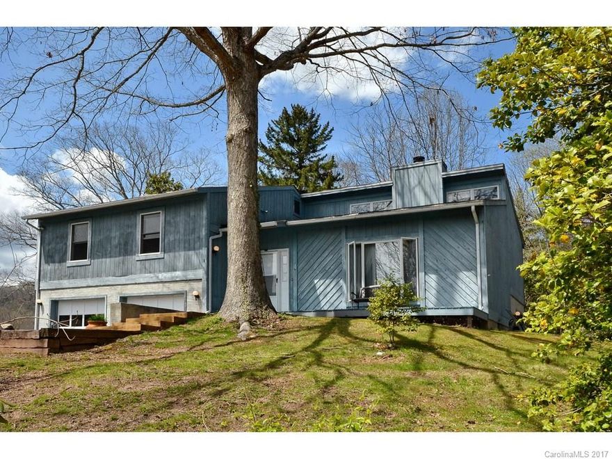 Good size home within walking distance of downtown.  Open floor plan with vaulted ceilings.  Formal living room and nice great room with lovely stone fireplace.  Family/Rec room in lower level with bath.  Large .85 acre lot with great yard.  Mountain views and priced to allow you to update.  Home being sold "as is"