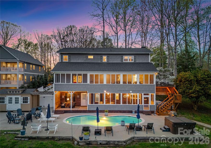 Live the Lake Norman lifestyle in this exceptional waterfront residence, nestled in a large cove with year-round deep water access. positioned on approximately 0.68 acres with no homeowner’s association, this fully furnished property presents a turnkey opportunity for primary residents, investors, or a second-home retreat. Designed for effortless indoor-outdoor living, the residence features a heated pool and spa, and a tiered outdoor layout with distinct zones for entertaining and relaxation. A two-story great room with fireplace opens to a traditional kitchen with granite countertops, two islands, wood cabinetry and a tile backsplash. The expansive sunroom, currently used as a dining room, spans the rear of the home and connects to both a screened-in porch and an open-air porch with steps to the pool. The main-level primary suite overlooks the water and includes a private screened porch, oversized walk-in closet and a spa-style bath with soaking tub, dual vanity, and custom tiled shower. Upstairs are two spacious bedrooms, two full baths and a second laundry. The walkout basement, ideal for hosting, includes a second full kitchen with bar seating, recreation space, a full bath and laundry room. A three-car garage provides ample storage and convenience. The private dock accommodates boating and jet skiing, while the calm cove is ideal for paddleboarding and protects your vessel from main channel exposure. Recent upgrades include a newer roof (2023), well pump (2022), resurfaced pool deck with propane heating (2021), main level and basement HVAC (2024), and A1 Pest Control service. Located just 40 minutes from Charlotte and minutes to The Village Shoppes, Publix, Starbucks and Chick-fil-A, this residence blends lakeside serenity with urban accessibility. Seller owns neighboring property, 4478 Power Dr, that is also for sale.