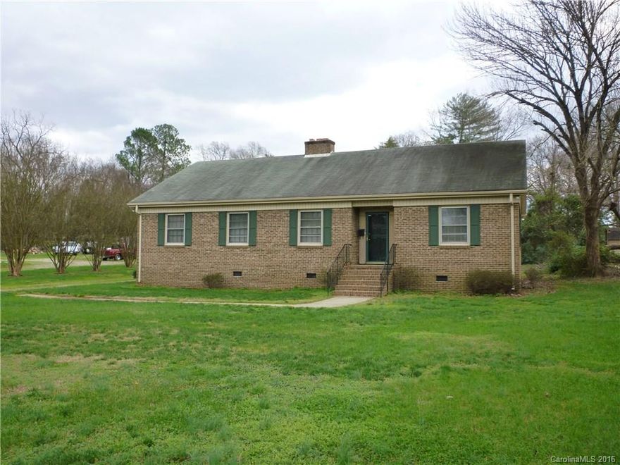 Classic brick ranch on large, level lot.  Large eat-in kitchen, hardwoods in many areas.  City water & sewer.  Living room & formal dining room, with cozy fireplace in Living room and Den.  Covered carport.  New carpet & paint.  Must see!