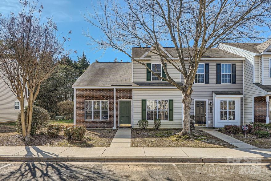 This beautifully designed end-unit townhome offers two assigned parking spaces & a welcoming layout perfect for comfortable living. Step inside & be captivated by the soaring ceilings in the great room, where a cozy fireplace serves as the focal point. The kitchen is thoughtfully designed with/ ample cabinet space, a breakfast bar, a pantry, & recessed lighting. The informal dining area opens directly to the back patio, backing to a serene treeline, creating an effortless flow for outdoor entertaining. The main-level primary suite features a double-door closet and an en-suite bath with dual sinks and a relaxing soaking tub. Upstairs, you'll find another spacious bedroom with generous closet space and a full bath featuring dual sinks and vinyl plank flooring. 3rd Bedroom, featuring two double closets and direct access to the full bath, offers flexibility as a home office. The home has vinyl plank flooring throughout the main level. The community pool is just steps away.
