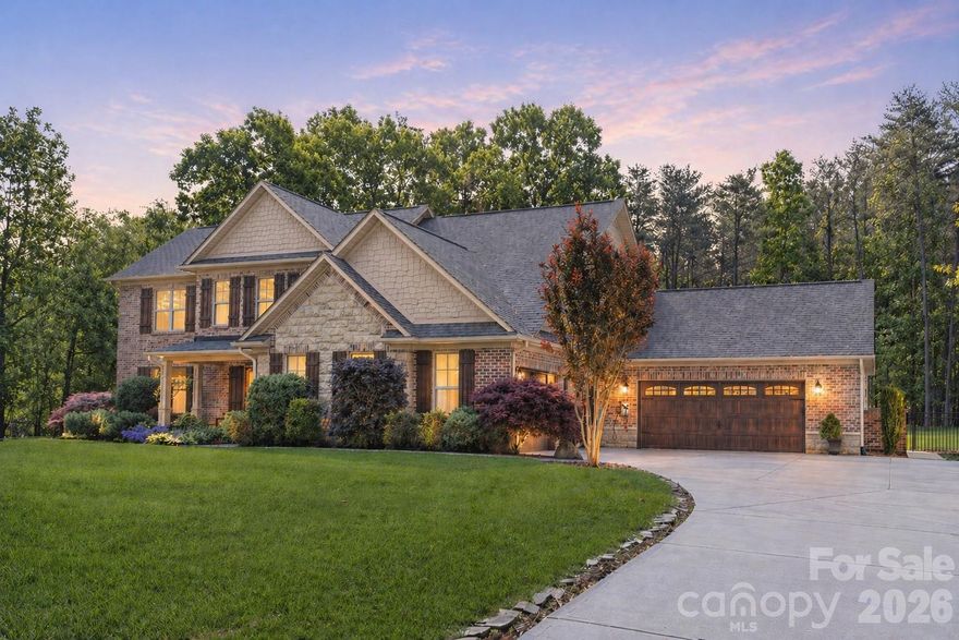 Tucked behind the gates of Pebble Bay's most coveted enclave, this meticulously maintained custom brick-and-stone estate delivers the rare trifecta serious buyers ask for and almost never find: a true 4-car garage, a resort-caliber outdoor living complex, and a chef's kitchen built for entertaining.
From the moment you arrive, the home's craftsmanship sets the tone. A stately full-brick and natural-stone façade, board-and-batten shutters, and lush, professionally maintained landscaping create a true curb-appeal moment — the kind of arrival that tells you the rest of the home will live up to the promise. It does.
Step out back and you'll understand why this property stands apart. The vaulted, tongue-and-groove covered pavilion anchors a fully-equipped outdoor kitchen featuring a built-in gas grill, side burner, stainless refrigeration, kegerator tap  — all framed in custom stacked-stone hardscape and warmed by recessed lighting overhead. An adjacent covered lounge with ceiling fans and a wall-mounted TV hookup makes year-round entertaining effortless, while a separate covered seating porch off the home offers a quieter retreat. Steps away, a custom water feature spills into a lava-rock basin surrounded by lantern-lit stone columns, and a sunken fire pit ringed by built-in stone seating and a stacked firewood alcove creates a private gathering space under the trees. Every paver, lantern, and stone was chosen with intention — and best of all, the septic field is positioned to allow for a future pool, so the estate-sized lot is ready when you are.
Inside, an open-concept floor plan showcases wide-plank distressed hardwoods, custom millwork, and designer tile throughout. The chef's kitchen centers on an oversized granite island with seating for five, a custom hood, glass-front cabinetry, double wall ovens, a gas cooktop, and a glass tile backsplash — all flowing seamlessly into a spacious great room with a floor-to-ceiling stacked-stone fireplace and built-in entertainment wall. The main-level primary suite is a true retreat, featuring a zero-entry spa shower, designer finishes, and walk-in closet space. The flexible floor plan accommodates up to 5 bedrooms plus two bonus rooms, giving you room to grow, work from home, or create the dedicated media, fitness, or guest space you've been wanting.
The 4-car garage — a genuine rarity at this price point — provides space for daily drivers, weekend toys, and a full workshop, all situated on an estate-sized lot with the privacy of mature woods. Combine that with low county taxes, the security of a gated community, and the lifestyle that Pebble Bay is known for, and the value here is simply unmatched.
Homes of this caliber don't come to market often in Pebble Bay. Schedule your private tour today.