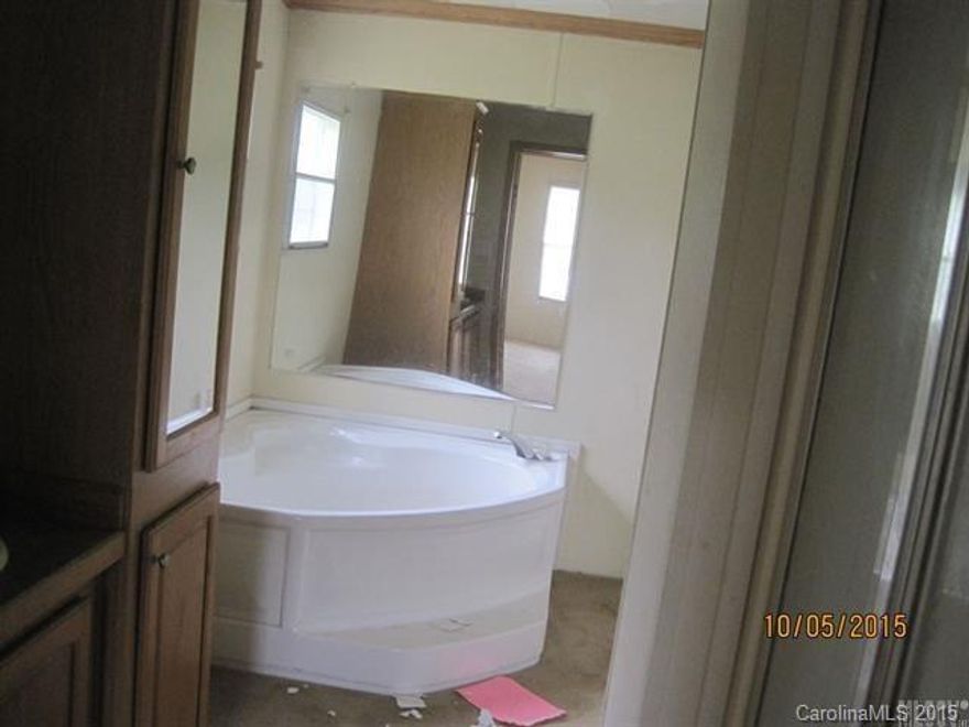 This is a large double wide home. A little TLC will turn this into a proud home. 3 bedroom 2 bath. Large den with a fireplace, level lot. There is a detached garage. The house needs some work on the walls and the inside air handler is missing but this has a lot of potential.