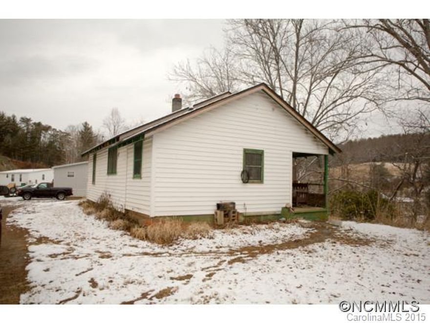 1930's 2 bedroom 1 bath 800 sq/ft home. Great E. Asheville location just minutes from the Blue Ridge parkway and in the Bell and Reynolds School District. Shared driveway.  Priced to sell. Great opportunity for investors.  This baby won't require a handyman, it will require a whole flock of handymen.Seller makes no representation of any kind.  Sold "as is"