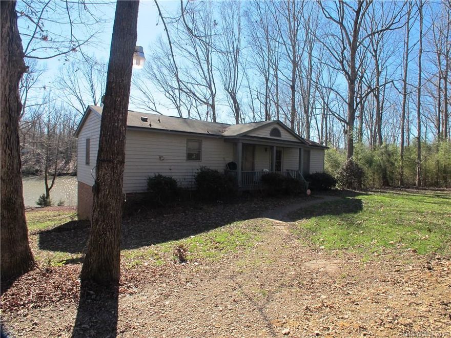 Private large winding road with deer and turkey brings you to this home on a gentle sloping lot with floating dock and lift. Fantastic view and wonderful fishing on lake with access to the main channel and not far from Buster Boyd Bridge. Home features a partially finished walk-out basement and great storage with double doors for easy lake access.