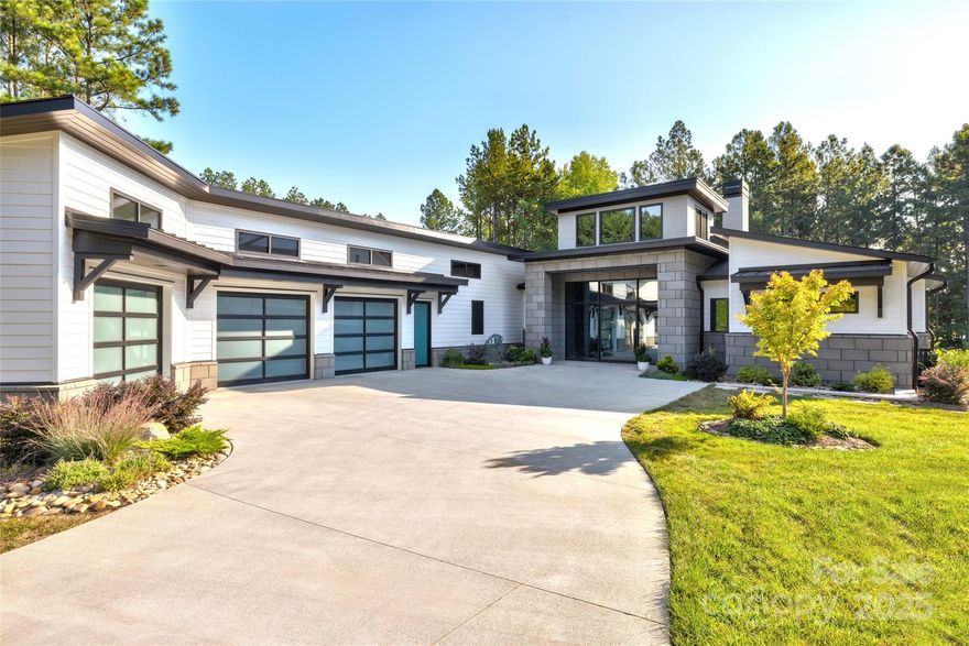 Introducing 241 Cape August Place—a one-of-a-kind custom estate in McLean Belmont, perfectly sited on 0.93 acres of waterfront serenity on Lake Wylie. Built in 2023, this 5,412 sq ft showpiece features 5 bedrooms, 5½ baths, with designer finishes throughout. A sweeping two-story foyer leads to an open-plan living area with floor-to-ceiling windows overlooking the pool and lush exotic landscape by a master landscape architect.
The heart of the home is a gourmet kitchen outfitted with Sub-Zero refrigeration, Gaggenau appliances, and a full outdoor kitchen for lakeside entertaining. A Savant home-automation system controls lighting, climate, audio, and security at the touch of a button. Storage is abundant—including a four-car fully conditioned garage—and peace of mind is assured with a Kohler 24 kW natural-gas generator.

Step outside to discover your resort-style oasis: a stunning pool and hot tub, flat walk to a private dock with sitting area and boat lift, and panoramic lake views. Whether across the water or across the globe, this rare Belmont residence offers luxury, technology, and lifestyle in perfect harmony. Priced at $3,699,999. —your opportunity to own Lake Wylie living at its finest.