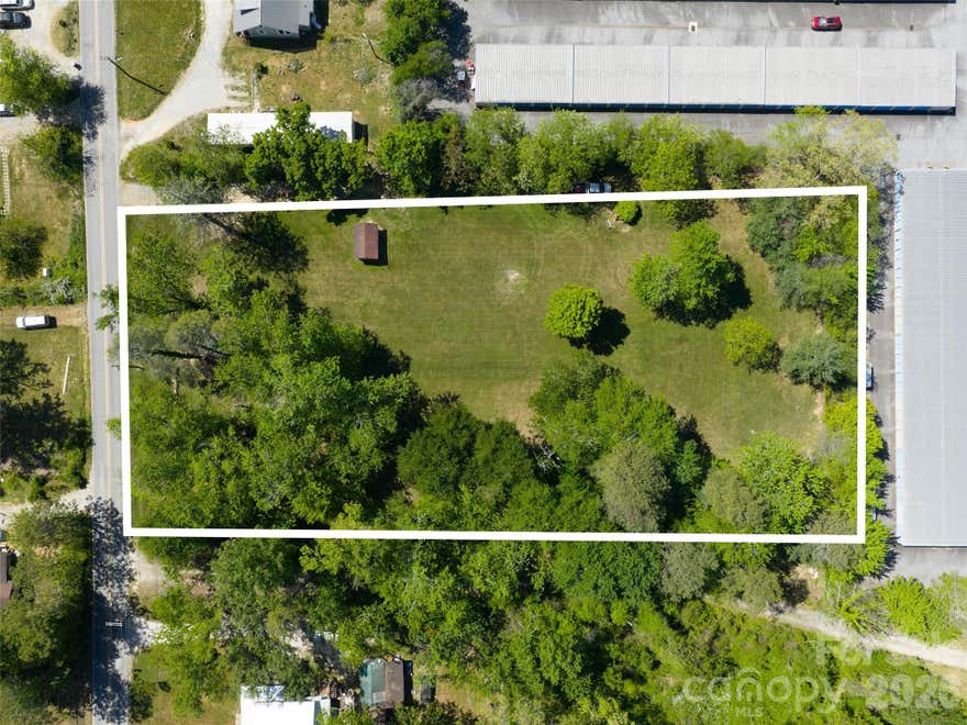 A rare opportunity to build, develop, or invest just one mile from downtown Hendersonville's Main Street shops, restaurants, and music. This level, mostly cleared 1.90-acre parcel offers a generous 362' × 228' rectangular footprint, ready for your vision.  Zoned R-15 and suited for residential or multi-family use, the lot accommodates everything from a private estate-style home to multiple homesites, subject to city approval. City water, electric, and natural gas are already on site. The property sits in Flood Zone X, outside the 100- and 500-year floodplains.
Jackson Park anchors the end of the road, with ballfields, trails, just moments away. A 30-foot right-of-way leads directly to the dog park. Grocery stores and daily essentials are all within easy reach.
No HOA. No covenants. Paved, publicly maintained frontage. Opportunities like this — real acreage, ready utilities, downtown-adjacent — don't surface often. Bring your plans.