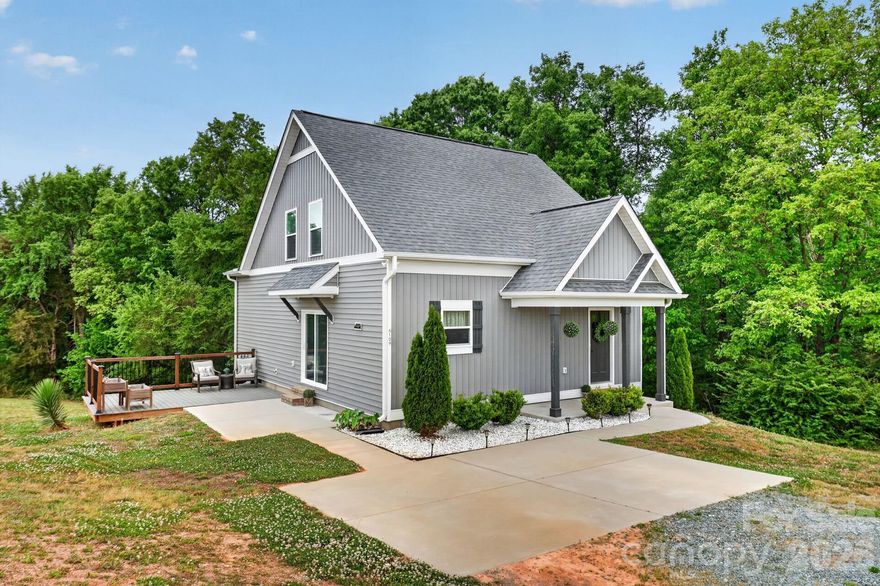 This home has 3 Bedrooms and 2 bathrooms(home has a 2 Bedroom Septic permit per Union County = 4 occupants) Move in ready, newer home, with over 1.5 acres, no HOA.  The covered front porch greets you, a sweet spot for coffee!  The front door with window, privacy surrounds you, with wooded views, tucked off the main road. Main living area is a huge great room, an open concept living space with a large kitchen and living area, flooded in light from the sliding glass doors.  Plenty of cabinet space, room to add an island, or a large dining room.  Main level primary suite with large walk in closet, another walk in utility area also used as additional storage/closet, with a full bathroom attached with a linen closet.  Upstairs you will find 2 more large bedrooms/ office / den with walk in closets, ceiling fans, and wonderful views of the surrounding countryside.  Outdoor entertaining is easy with large patio right off the living area and an added deck area.  2 car parking spaces, lovely landscaping, perfect peaceful setting surrounded by nature.  There is a shared well agreement (FHA/Lender Compliant), shared driveway.  Main level laundry with additional storage, just off main living area!  Entire home has Vinyl plank flooring for easy living, stairs are hardwood as well! Water filter system at kitchen sink.  Welcome Home!