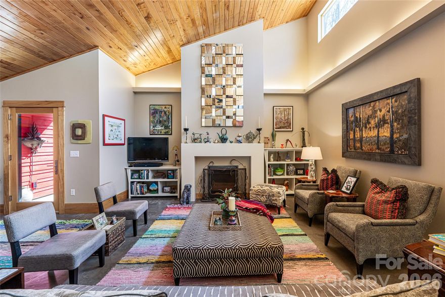 'The Sawtooth House' pairs elegant simplicity with sustainable performance and deep responsibility. LEED Silver 'Parade of Homes' 2013 winner for both innovation and craftsmanship. Located in the sustainably planned private 38-acre neighborhood of 'Greenwood', this home of the future rests seamlessly within a thoughtfully designed green sanctuary! The solar elements of 'The Sawtooth House' serve as stunning architectural features. The climate-responsive design incorporates a geothermal heat pump with a heat ventilator HRV recovery system, keeping temperatures and air quality optimized. The standing-seam metal sawtooth roof design allows the sun to passively dance through 16' clerestory triple-pane high-level UV windows protecting your art! Photovoltaic solar panels feed three batteries for year-round electric independence, juicing your electric vehicle & procuring monthly winter electric bills in the teens! This distinctive home and grounds have been twice featured in 'Carolina Homes + Garden' magazine. The grounds have been tailored to honor existing century-year-old rhodo thickets and designed with hydrangeas, native azaleas, dogwoods, grasses, a stunning Japanese maple collection, and an array of perennials over an invisible stormwater and erosion-control system carrying roof drainage and runnoff to a rain garden complete with boulders. Four seasons dramatically play throughout this 'landscape of meaning' designed as The Courtyard, The Meredies (south), The Vespere (west), and the native woodland gardens. So exquisite in their collective designs that they become the lead stars in the published 'Devotion: Diary of an Appalachian Garden.' 
Two individual sculptures, along with the custom gate and wrought iron railings, complete the masterpiece. 
By appointment only, with inspiration from the seasons.