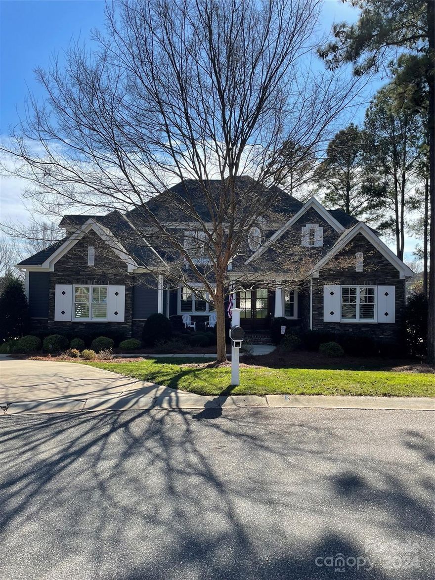 Nantucket-Style Arthur Rutenberg Gem in The Point. Lake Norman views and deeded boat slip! Welcome guests through an elegant foyer with curved staircase leading to a wonderful floorplan with an abundance of natural light. Enjoy main level owners retreat with beautifully appointed spa bath, home office with beamed ceilings, formal dining and a spectacular kitchen with hidden pantry.  Upper level offers 3 bedroom suites with private baths, media room and bonus/exercise room. Enjoy lake views from your porch with custom phantom screens or entertain on second covered porch with fireplace and outdoor kitchen. Fantastic paver outdoor entertaining space with fire pit and fully fence yard. Boat slip is located at Pier Z at the end of Broad Sound with Parking, Slip 81.