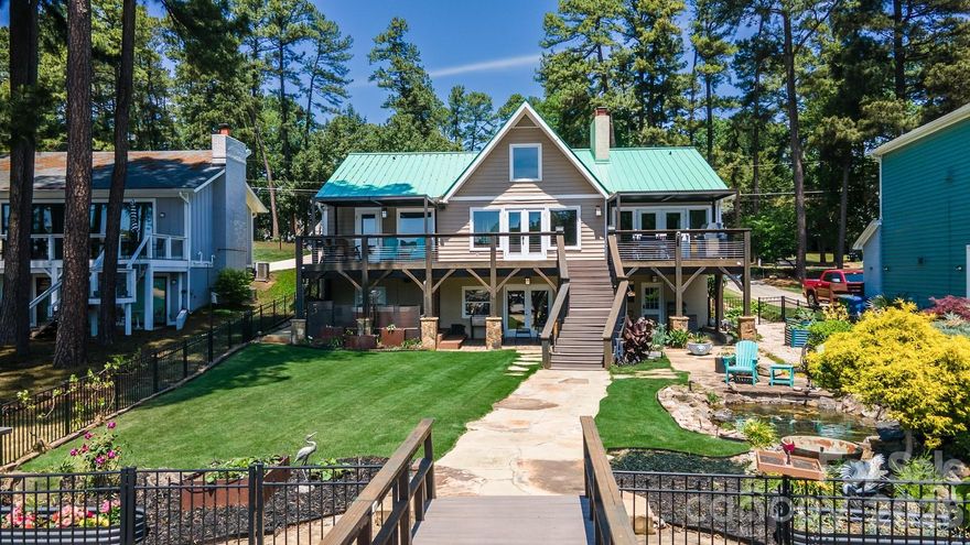 Premier waterfront home with majestic main channel views of Lake Norman!  Surrounded by water, this home is situated in the highly desirable Island Forest neighborhood; facing southwest allows for magnificent sunsets! The aerial photos tell it all!  Spacious, open floor plan. Beautiful bamboo hardwood floors in dining room, great room and loft. Awesome kitchen complete with granite/wood countertops, breakfast bar, tile backsplash, gourmet gas stove, vented hood and plenty of cabinet space. Large, open great room features vaulted ceiling, gas masonry fireplace and wonderful natural light. Wake up to lake views from the large, main level primary bedroom. Upper-level loft is perfect for a reading area or playroom. Large entertaining area on lake level offers ample space for pool table, wet bar area, plenty of living space and 2nd masonry fireplace with gas logs.  Absorb breathtaking views from the upper deck or covered lake level patio. Hot tub located directly off the large covered back porch offers wonderful opportunities to unwind anytime.  Striking metal roof adds to the lake-house feel. Beautifully landscaped yard features zoysia grass, mature palm trees, stone walkways, fully fenced backyard, fully functional Koa Pond. Expansive pier includes covered sitting area and 10,000lb boatlift. Tankless water heater, Generac generator, "lake water" in-ground irrigation.  Island Forest neighborhood offers private/gated (residence only) waterfront lot complete with boat ramp and pier! Prime location near parks, restaurants, and boutique shopping.   This residence defines the vibrant Lake Norman way of life! Experience the ultimate Lake Norman lifestyle!