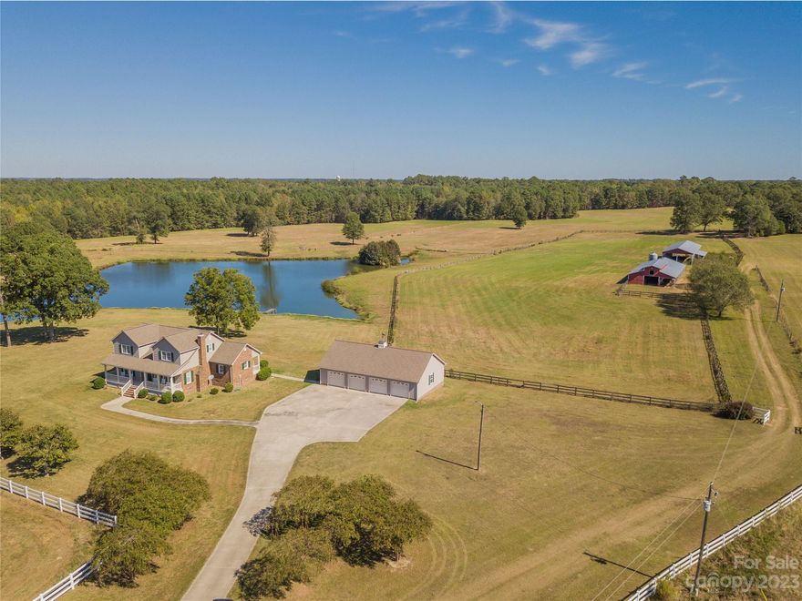 Come see this piece of paradise. The beautiful house is tucked away from the road with the Master Bedroom on the main level and a gorgeous sunroom overlooking the pasture. Property includes two large barns and extra deep four-bay garage with work bench and cabinets. Pasture is all cleared and cut and entirely fenced. White vinyl fence up front with wire mesh horse fence on remaining sides. Multiple gates throughout to isolate one pasture from another. Three water stations included. There is also a cattle shoot and holding pen. You'll find a diesel fueling station at one barn. There are also two hay rings and a water trough. One barn with hay loft and stalls. The other is open on three sides. Two stocked ponds approximately three to four acres each. This property is absolutely gorgeous. Scenic views everywhere you look. Schedule a tour today!