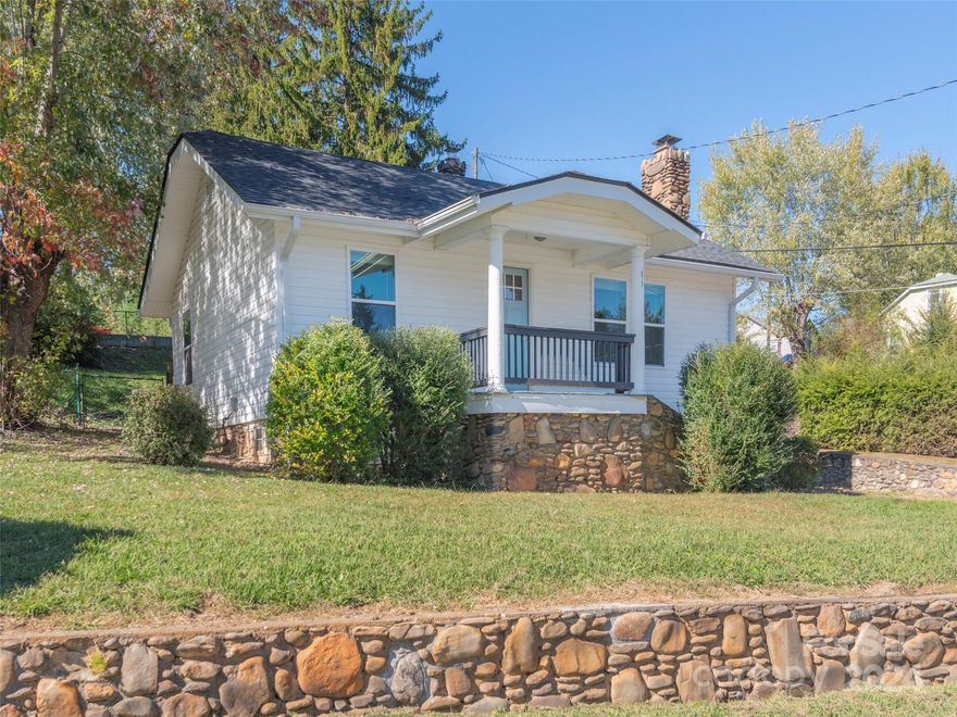 No storm damage. Updated 3 bedroom 1 bath home on a hill with a fenced in backyard, private driveway with room for 2+ cars. Renovated in 2022 with new roof, heat pump, appliances, flooring and paint. Wood floors under most carpeted areas could be re-finished. Fireplace has been enclosed, perfect of an electric insert of decorative unit. Spacious kitchen, granite countertops, with stainless steel appliances. Updated bathroom with tiled bath/shower surround. Tile floors in bathroom and kitchen. Unfinished basement would make a great workshop. This adorable home is move in ready, perfect for first time buyers or a lovely vacation home in the mountains. Convenient to Asheville, downtown Canton, and Waynesville. Sellers are offering a $2,000 credit toward replacement of carpet.