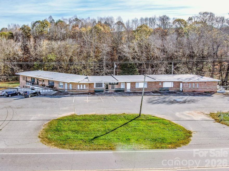 10 unit strip mall available in a prime location off of Hwy 21 with just under 500 feet of road frontage!  This is a Statesville address but just outside of Troutman and near the approved 774 acre residential/retail development Wakefield Village in Barium Springs.  The building has 2 levels with 5 units up and 5 below with the potential to go to 12. Two units upstairs and two units downstairs have been combined.  Each unit has a restroom, all are metered separately for power. Septic and city/county water.  Zoned Neighborhood Business which allows for a multitude of approved uses.  Some repairs and updates are needed so it's priced to sell!  Owner is also selling 3.58 acres adjacent to this property. See  MLS 4335421.